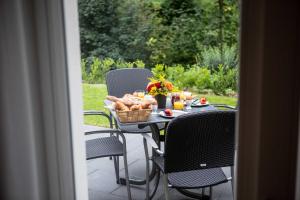 a table with a basket of bread and flowers on it at Siegelsbacher Muehle in Siegelsbach