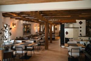 a restaurant with wooden ceilings and tables and chairs at Siegelsbacher Muehle in Siegelsbach +34 photos