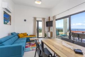 a living room with a blue couch and a table at Apartments Luna in Malinska