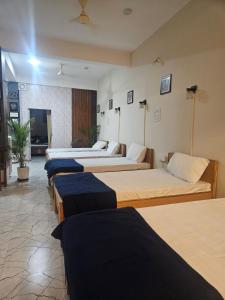 a group of four beds in a room at Rahat Dormitory in Jāmb