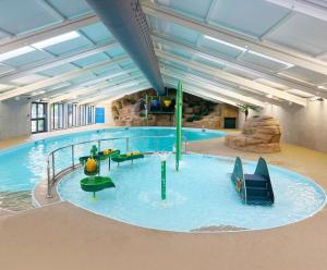 a large indoor swimming pool in a building at St. Ives Holiday Village in St Ives