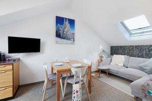 a living room with a table and a couch at Ferienwohnung Black Forest Hideaway in Todtnau