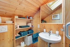 a bathroom with a sink in a wooden cabin at Ferienwohnung Black Forest Hideaway in Todtnau +30 photos