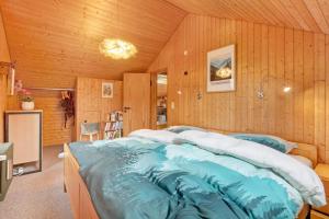 a large bed in a room with wooden walls at Ferienwohnung Black Forest Hideaway in Todtnau