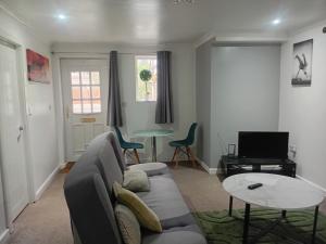 a living room with a couch and a table at Shetcliffe Lodge in Dudley Hill