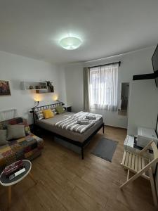 a bedroom with a large bed and a couch at B&B Isola in Izola