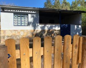 a wooden fence in front of a house at Quinta da Ana, Casa de Roça in Baependi