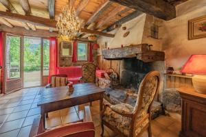 a living room with a table and a fireplace at La Barraço in Nalzen