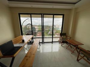 a room with a table with a laptop on it at Xenia Backpackers in Nairobi