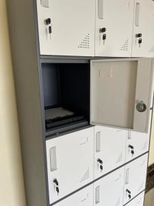 a stack of white cabinets with their doors open at Xenia Backpackers in Nairobi