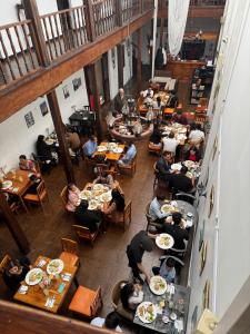 a group of people sitting at tables in a restaurant at Mansión del Parque by CS in Guaranda +20 photos