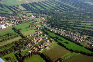 an aerial view of a village with houses and trees at Ferienzentrum Brouwer, 75010 in Westoverledingen
