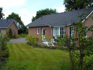 a brick house with a lawn in front of it at Ferienzentrum Brouwer, 75010 in Westoverledingen
