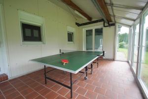 a ping pong table in the middle of a room at Ferienzentrum Brouwer, 75010 in Westoverledingen