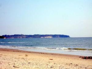a sandy beach with the ocean in the background at Ruegen_Fewo 233 in Groß Zicker