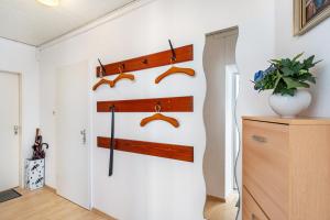 a room with a wall with wooden hooks and shoes at Apartment Korthals 42 in Wangerland