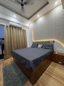a bedroom with a large bed with a wall at THE COZY STAY STUDio in Greater Noida