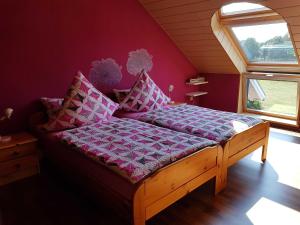 a bed in a room with a purple wall at Ferienwohnung Hahn, 95129 in Rhauderfehn