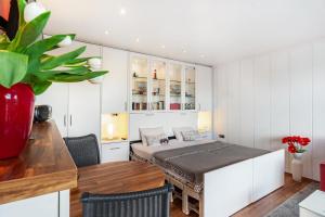 a bedroom with a bed and a table and chairs at Apartment Korthals 42 in Wangerland