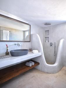 a bathroom with a large sink and a shower at Mouragio Stay - Aliki , Paros in Aliki
