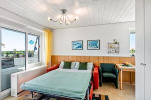 a bedroom with a bed and a desk and a table at Apartment Korthals 41 in Wangerland