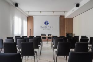 a conference room with black chairs and a table at Parioli Hotel Rimini in Rimini
