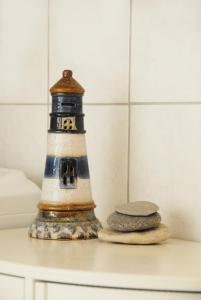 a lighthouse sitting on a table next to two stones at Ferienwohnung Himmelblau in Strullendorf