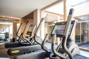 a row of exercise bikes in a gym at PAPA RHEIN - Hotel & Spa in Bingen am Rhein