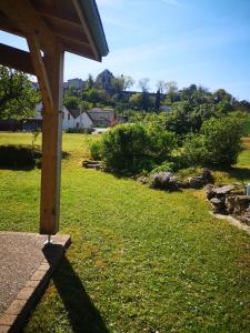 a shadow of a wooden structure on the grass at Blue Banane in Monflanquin