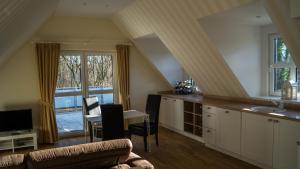 a living room with a couch and a table and a window at Hotel Haus Broichtal in Alsdorf