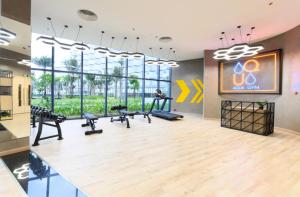 a gym with treadmills and exercise equipment in a building at Arena jakovi condotel in Cam Lâm