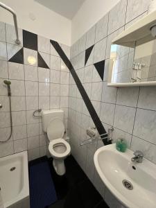 a bathroom with a white toilet and a sink at Vila Rosa in Tkon +34 photos