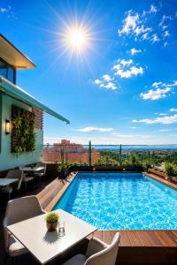 a pool on a balcony with a table and chairs at Appart-hotel Marrakech Inn in Marrakesh