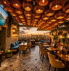 a restaurant with tables and chairs and a view of the city at Appart-hotel Marrakech Inn in Marrakesh