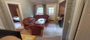 a living room with two couches and a table at timber cabin Eresfjord med båt til leie in Øverås