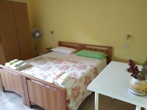 a small bedroom with a bed and two tables at B&B Josefine in Marina di Camerota +6 photos