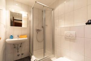a bathroom with a shower and a sink at Haus Windböe, Wohnung 3 in Duhnen +4 photos
