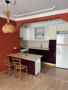 a kitchen with a table and chairs and a refrigerator at Buena Vista Hotel&Restaurant in Marmaris