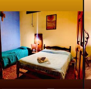 a bedroom with a bed with a towel on it at Cafayate Backpackers in Cafayate