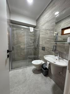 a bathroom with a shower and a sink and a toilet at Midas Pension in Dalyan