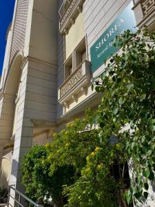 a building with a tree in front of it at شقق الشرفة للشقق المفروشة -AlSHORFA FURNISHED APARTMENT in Riyadh +17 photos