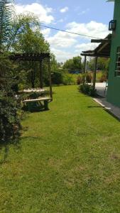 a park with a picnic table in the grass at Casa Quinta Doña María in Concepción del Uruguay