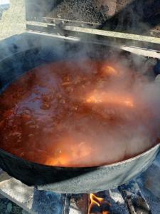 a large pot of food cooking on a grill at Casa Quinta Doña María in Concepción del Uruguay
