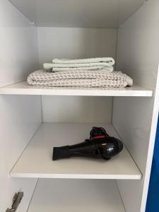 a shelf with two towels and a bottle on it at Apartment on Angisa, 78 in Batumi