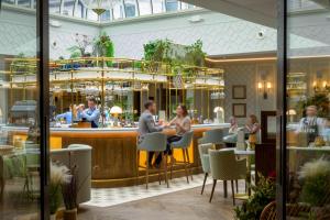 a group of people sitting at a bar in a restaurant at Marcliffe in Aberdeen +96 photos