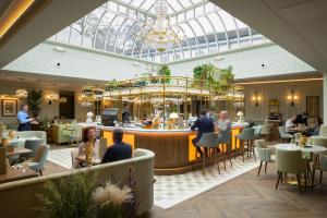a restaurant with a bar and people sitting at tables at Marcliffe in Aberdeen