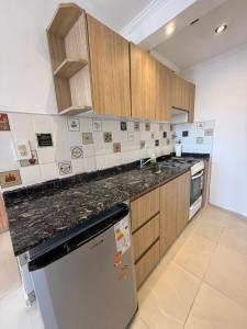 a kitchen with wooden cabinets and a counter top at Panoramico in Santa Teresita