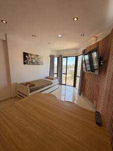 a bedroom with a bed and a large window at Panoramico in Santa Teresita