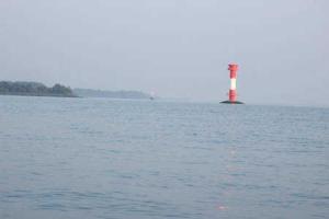 a red and white lighthouse in the middle of a body of water at Best of Kollmar - Apartment mit Terrasse für 2 Personen absolut ruhig in Kollmar