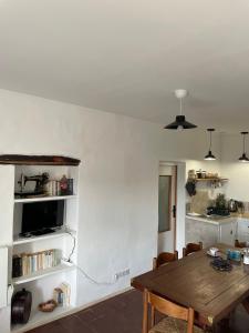 a dining room with a table and a kitchen at Lortu vivu in Castifao +32 photos